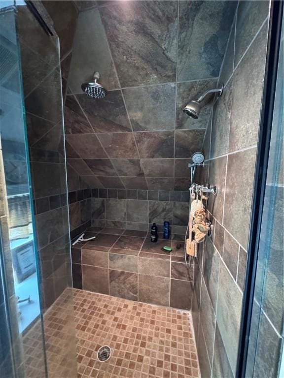 full bath with a tile shower