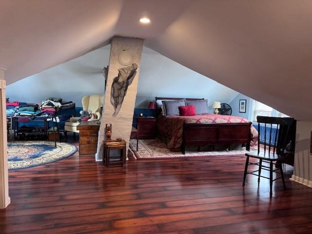 bedroom with vaulted ceiling, recessed lighting, and hardwood / wood-style floors