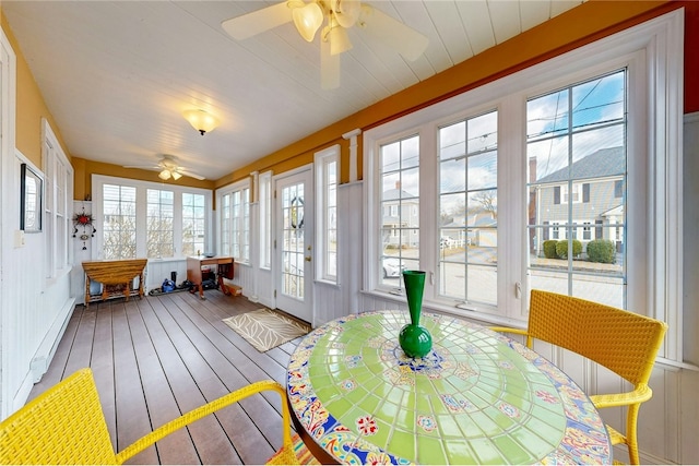 sunroom / solarium with a ceiling fan