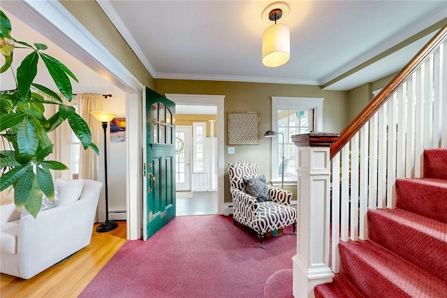 interior space featuring stairway, wood finished floors, baseboard heating, and ornamental molding