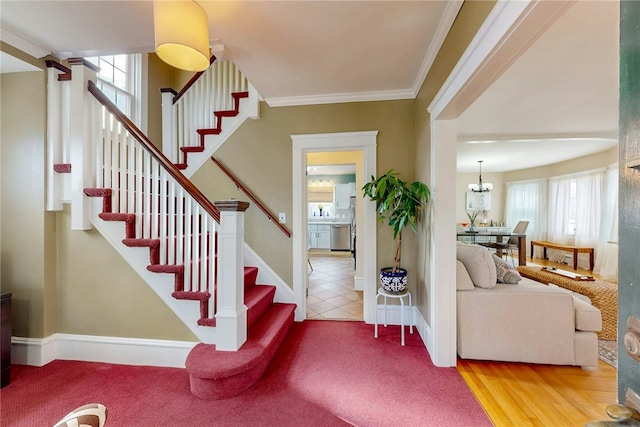 interior space with stairs, baseboards, tile patterned flooring, and ornamental molding