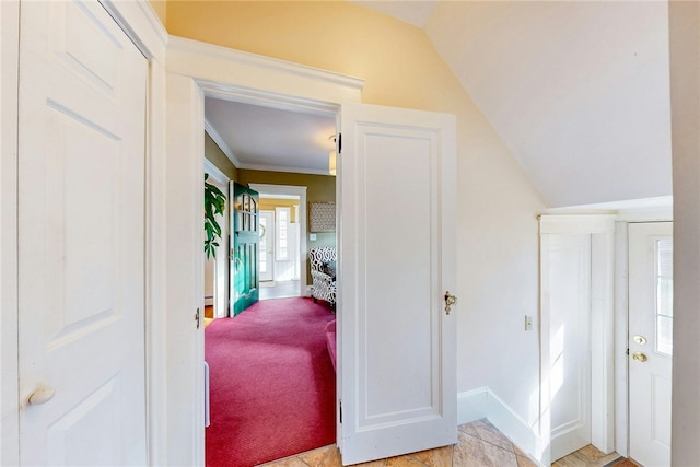 corridor with light colored carpet and lofted ceiling