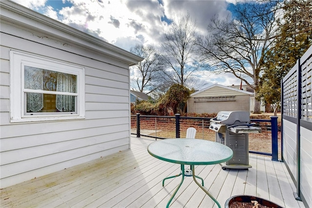 wooden deck featuring a grill