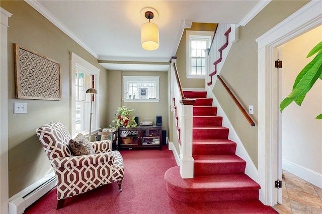 interior space featuring a baseboard heating unit, baseboards, and crown molding