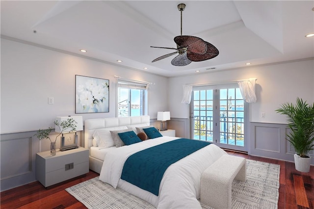 bedroom with a wainscoted wall, recessed lighting, wood finished floors, and access to outside