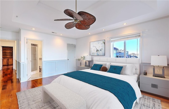 bedroom featuring ornamental molding, recessed lighting, wood finished floors, and wainscoting