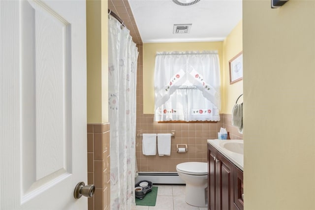 full bath with visible vents, a baseboard heating unit, toilet, tile patterned floors, and tile walls