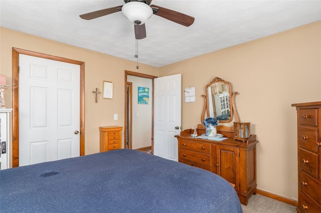 carpeted bedroom featuring a ceiling fan and baseboards