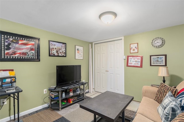 living area featuring baseboards