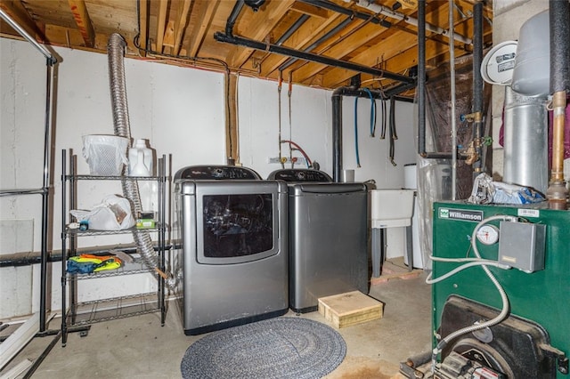 laundry area with laundry area, washing machine and dryer, and a heating unit