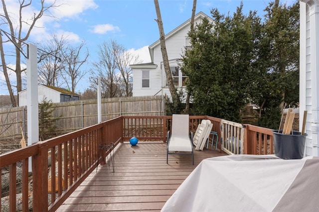 wooden terrace featuring fence