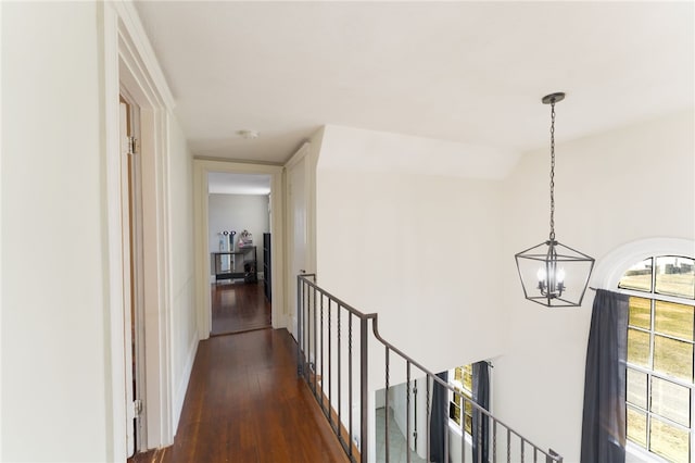 hall featuring a notable chandelier and wood finished floors