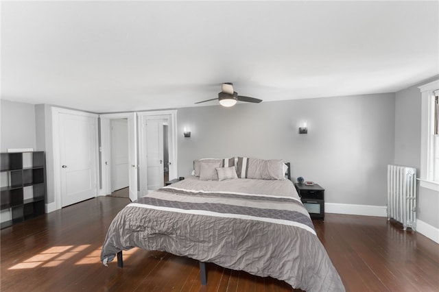 bedroom with radiator heating unit, wood finished floors, baseboards, and ceiling fan