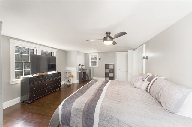 bedroom with dark wood-type flooring, baseboards, and ceiling fan