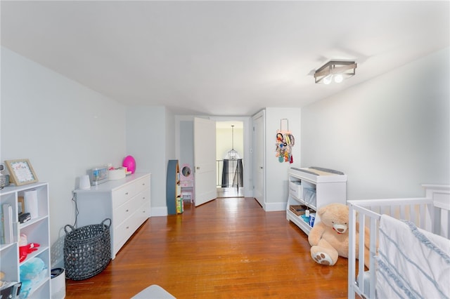 bedroom featuring wood finished floors and baseboards