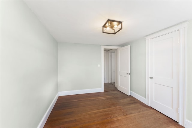 interior space with baseboards and wood finished floors