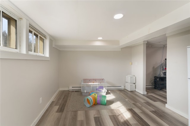 rec room with recessed lighting, baseboards, and wood finished floors