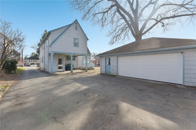 exterior space featuring an outbuilding and a garage