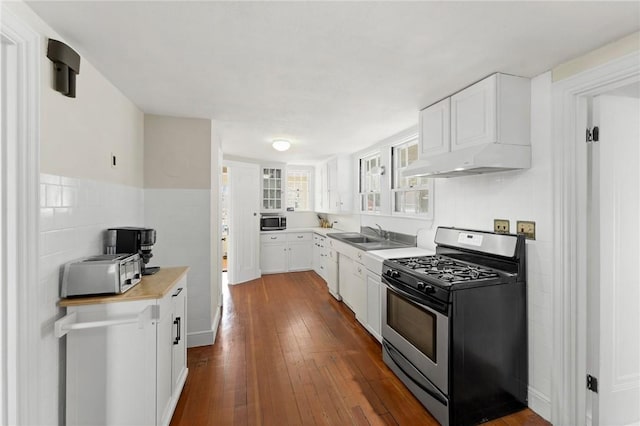 kitchen featuring dark wood finished floors, white cabinetry, and stainless steel appliances