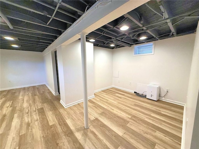 basement with wood finished floors and baseboards