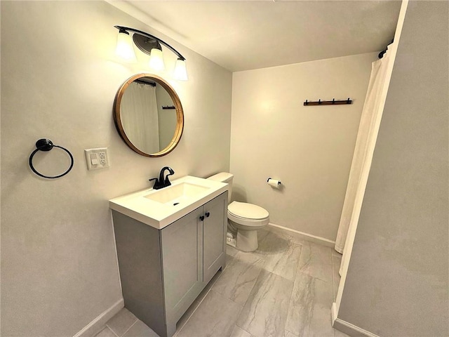 full bathroom with vanity, toilet, baseboards, and marble finish floor