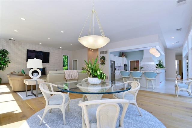 dining room with light wood-style flooring, recessed lighting, and visible vents