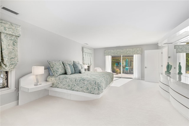 bedroom with access to exterior, visible vents, carpet flooring, and baseboards