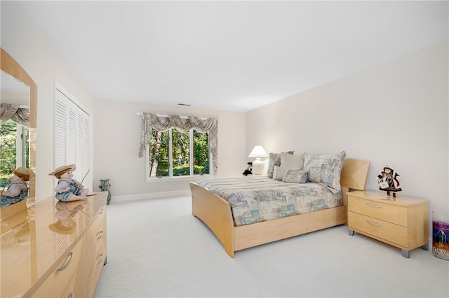 bedroom with light colored carpet, visible vents, and baseboards