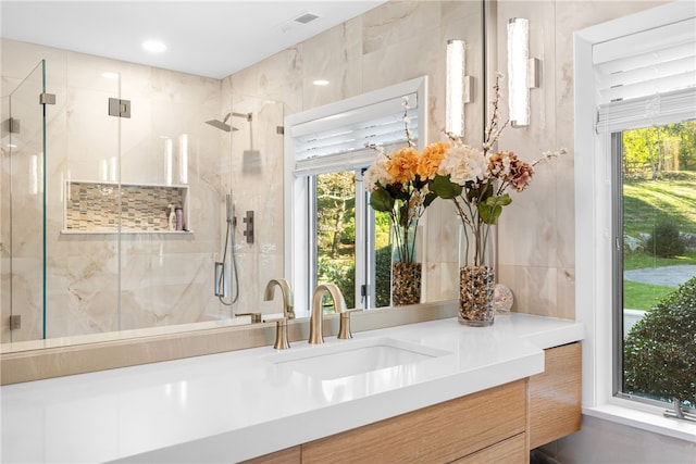 full bathroom with visible vents, a stall shower, and vanity