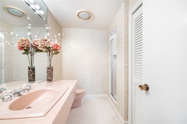 full bath featuring toilet, tile walls, a shower stall, tile patterned flooring, and vanity