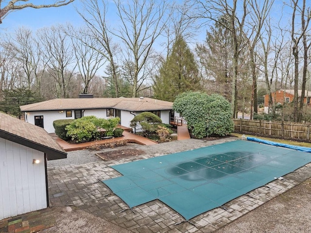 view of pool with a patio area and fence