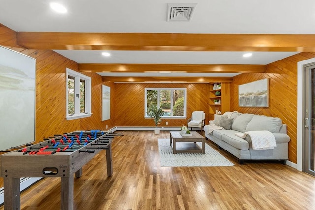 game room with visible vents, beamed ceiling, baseboards, and wood finished floors