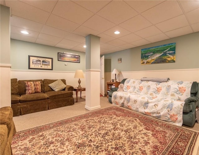 carpeted living area with recessed lighting and a paneled ceiling