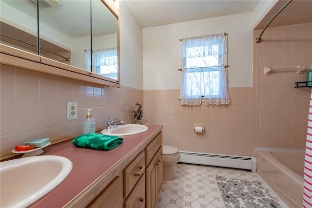 bathroom with tile walls, toilet, a baseboard heating unit, and a sink