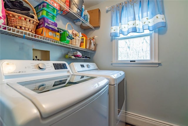 laundry room featuring a baseboard heating unit, laundry area, and washing machine and dryer