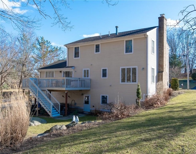 back of house featuring stairway, a lawn, a wooden deck, and a chimney