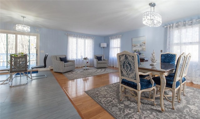 dining area with an inviting chandelier and wood finished floors