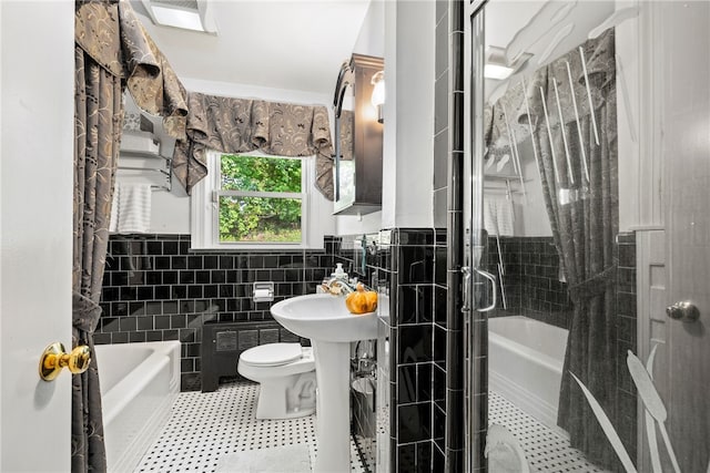 bathroom with a tub, tile walls, walk in shower, and tile patterned floors