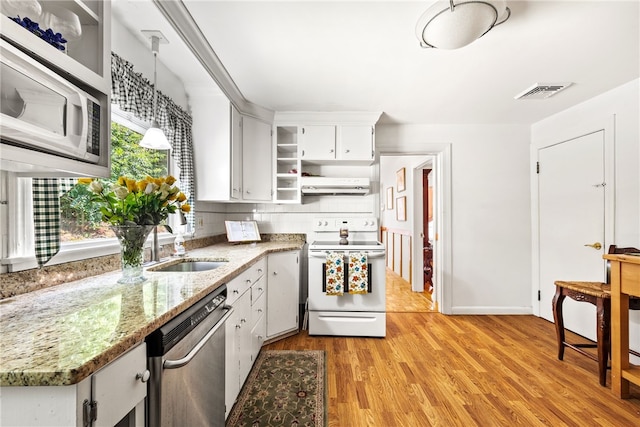 kitchen featuring visible vents, a sink, under cabinet range hood, white appliances, and open shelves