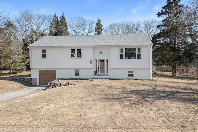 bi-level home with an attached garage and driveway