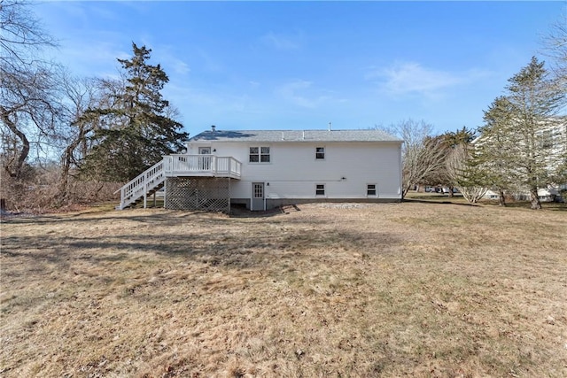 rear view of property with a wooden deck, a lawn, and stairs