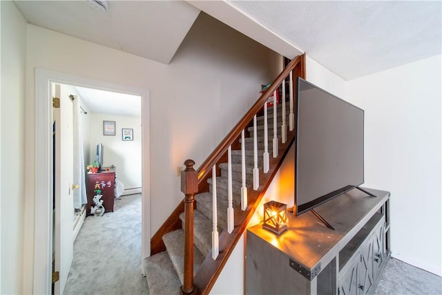 staircase featuring carpet and a baseboard radiator