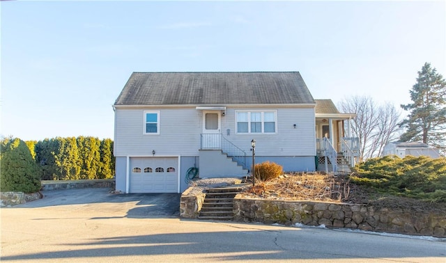 single story home featuring concrete driveway and an attached garage