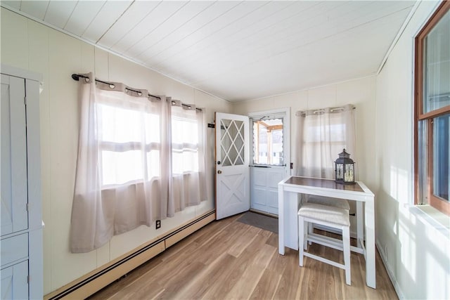 interior space with light wood-type flooring, baseboard heating, and wood ceiling