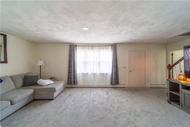 living area with baseboard heating, carpet flooring, and a textured ceiling