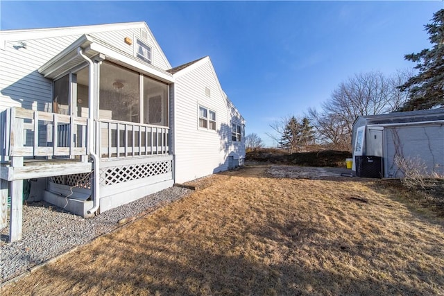 view of home's exterior with a sunroom