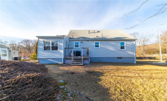 back of house featuring crawl space, a wooden deck, and a yard