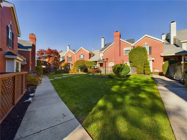 view of yard with a residential view and fence