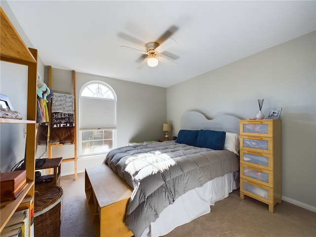 carpeted bedroom featuring baseboards and ceiling fan