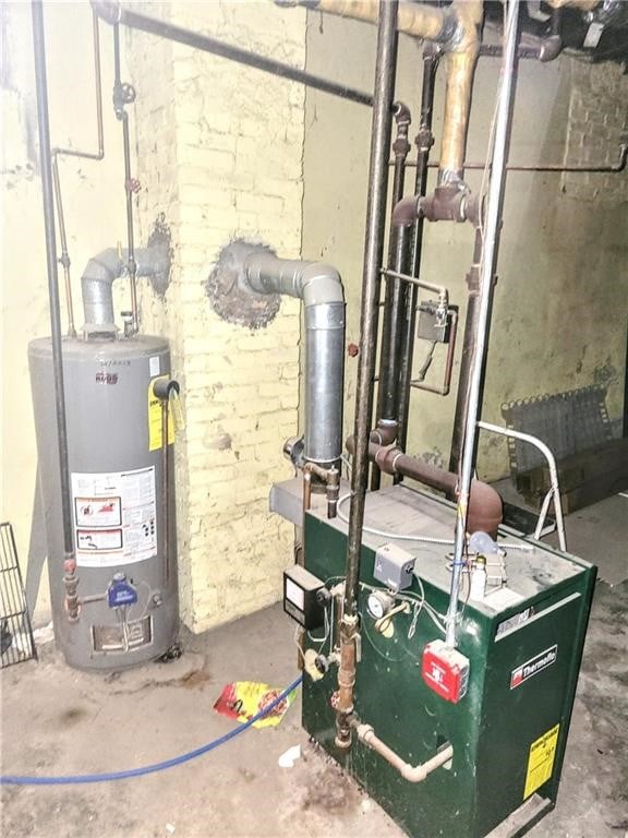 utility room featuring a heating unit and water heater